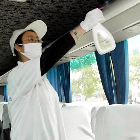 Employees of Beijing Capital Taxi Co spray disinfectant over their traveling coaches in Beijing in 2003, amid the SARS outbreak.
