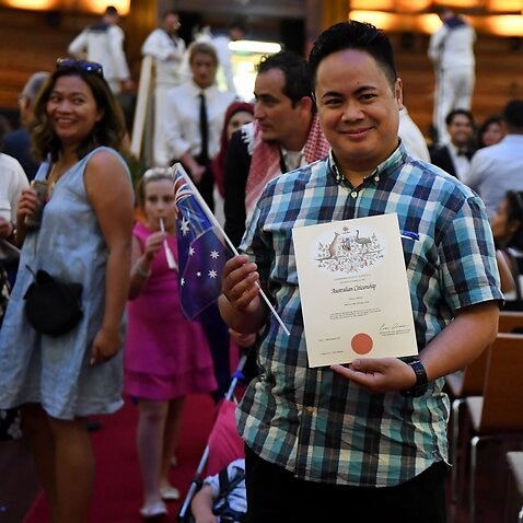 An Australian citizenship recipient poses for a photo after  a citizenship ceremony on Australia Day in Brisbane, Thursday, Jan. 26, 2017. (AAP Image/Dan Peled) NO ARCHIVING