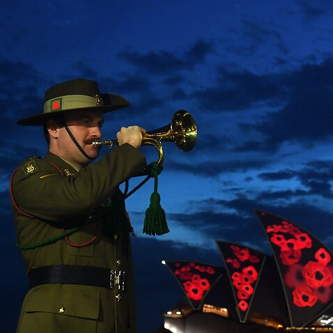 Poppies are projected onto the Sydney Opera House sails during a Remembrance Day 2021 dawn service