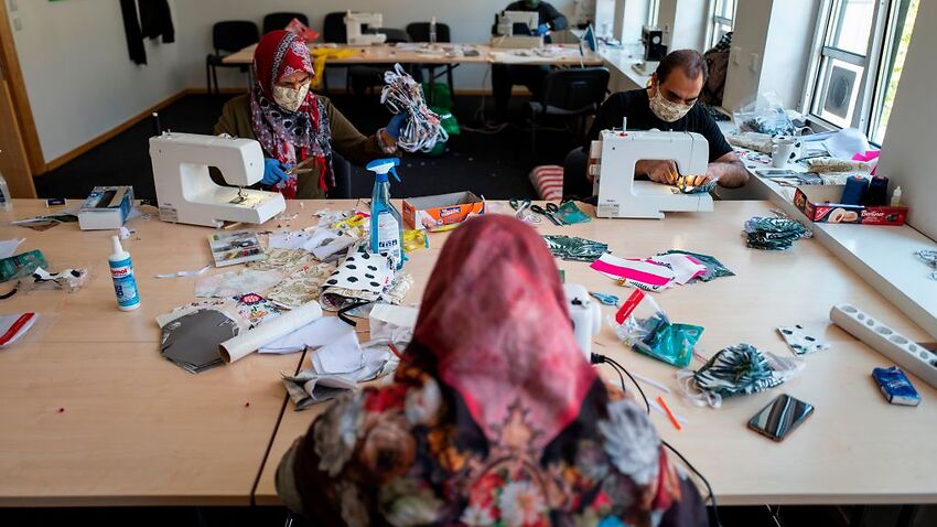 Refugees from Afghanistan sew face covers in Berlin amid the coronavirus pandemic.
