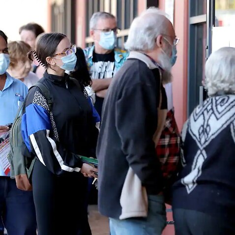 Voters queue outside an Australian Electoral Commission