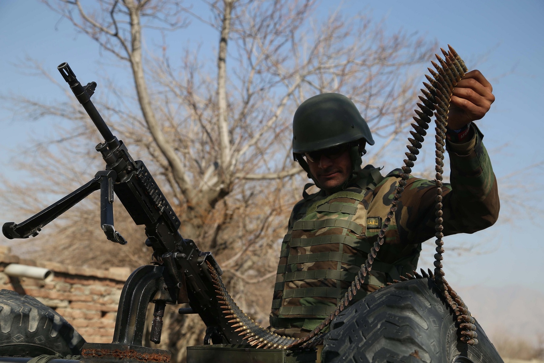 An Afghan Army soldier stands guard at a check point near the Shirzad district in Hogyani district of Nangarhar province, Afghanistan.