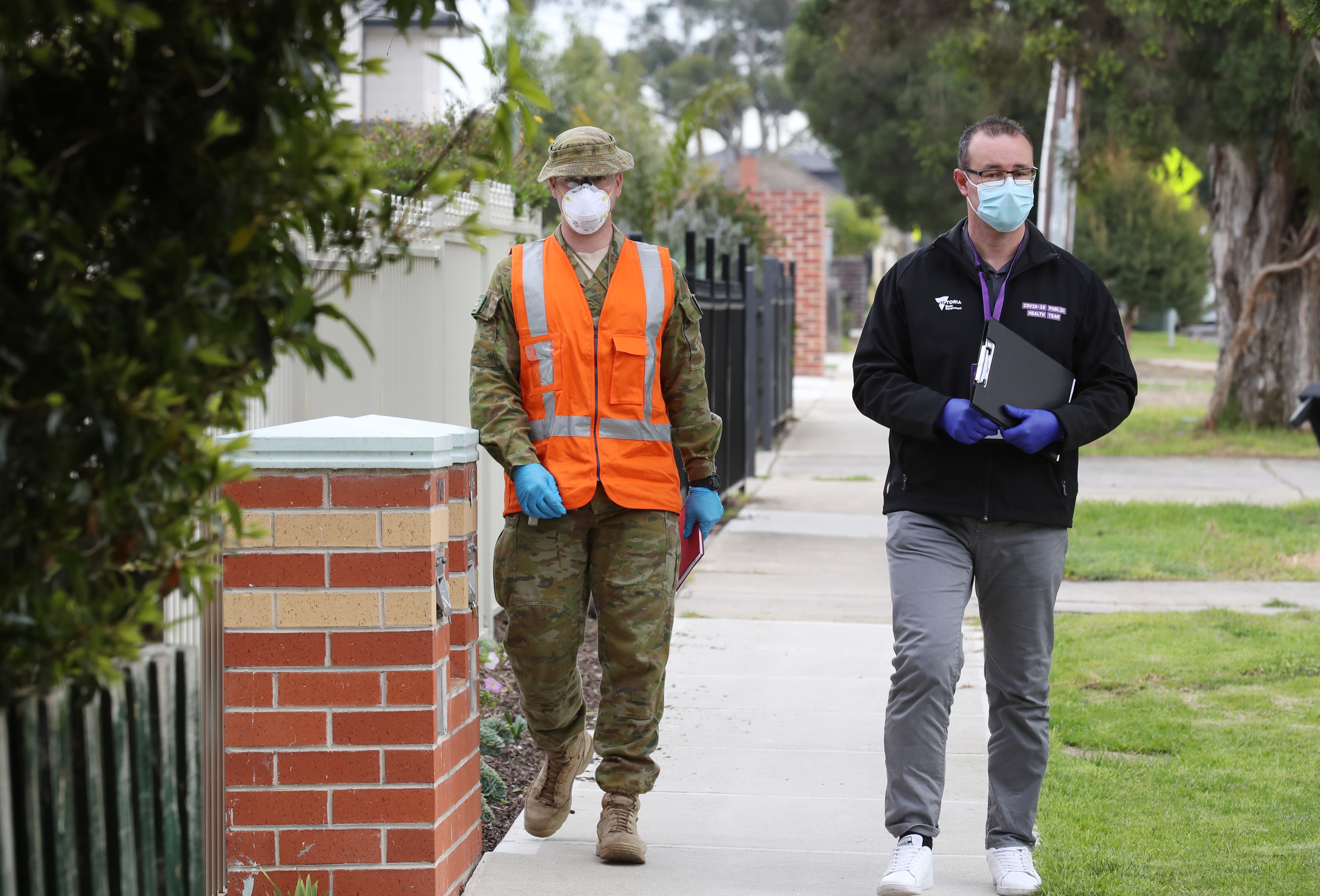 ADF personnel and public health officials doorknocking houses in St Albans.