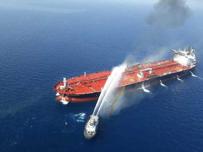 Iranian navy boat try to control a fire on the crude oil tanker Front Altair in the Gulf of Oman, 13 June 2019. 