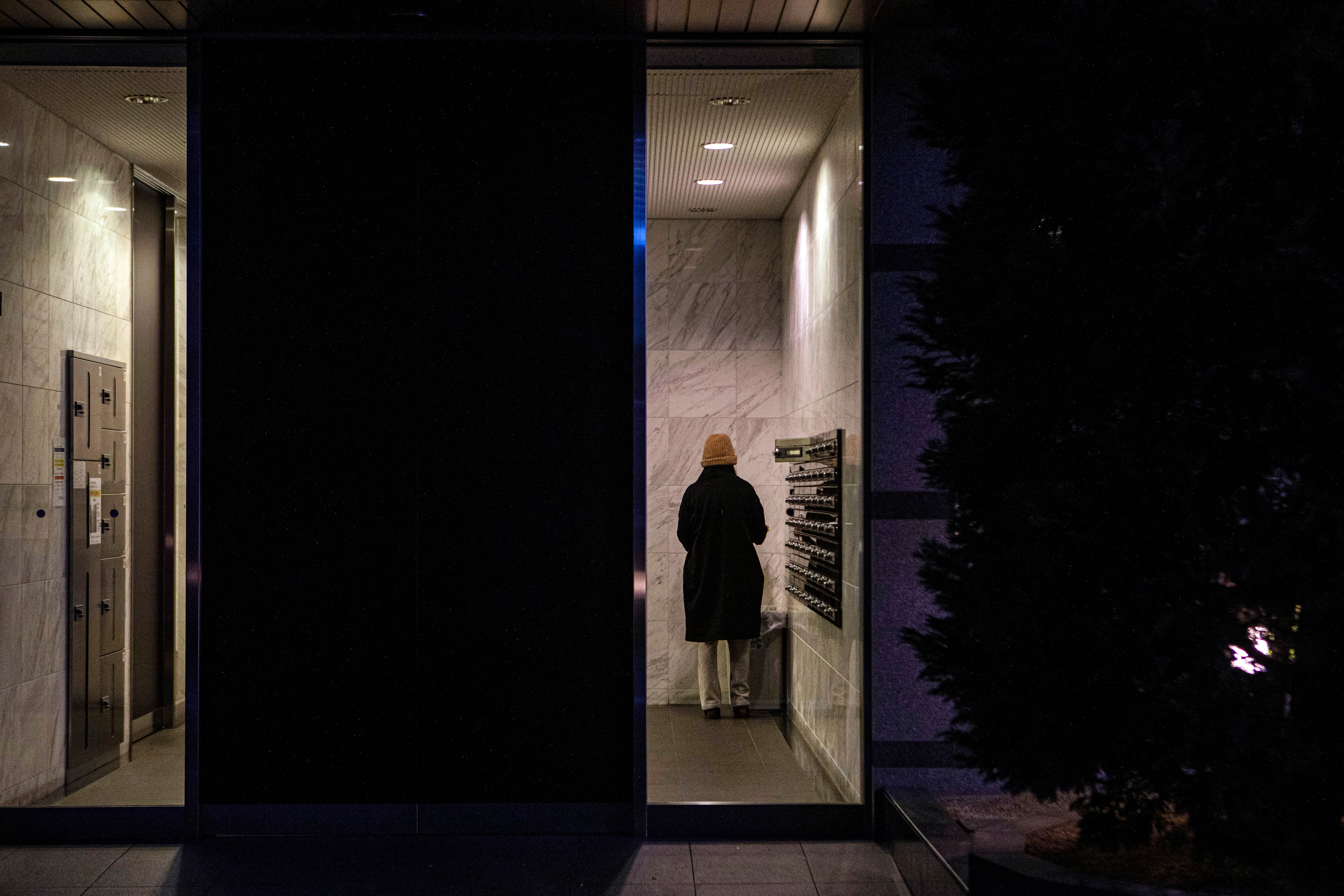 A woman retrieves mail in the lobby of an apartment building in Osaka, Japan, on 20 February, 2021.