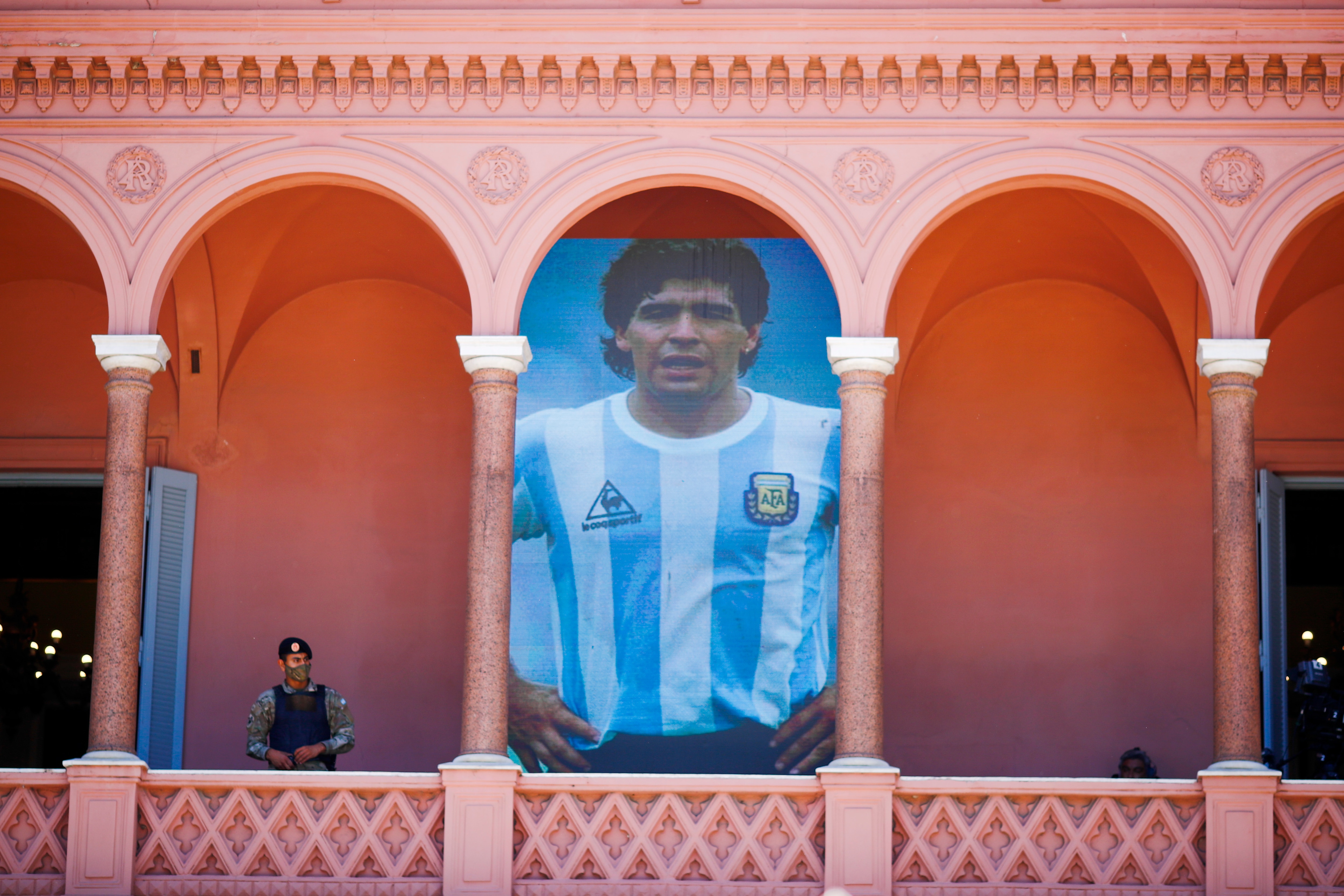 Diego Maradona displayed on a balcony of the presidential palace known as the Casa Rosada or Pink House.