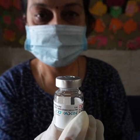A health worker shows a vial of Covaxin during a vaccination drive against coronavirus inside a school in New Delhi, India on 20 October, 2021. 