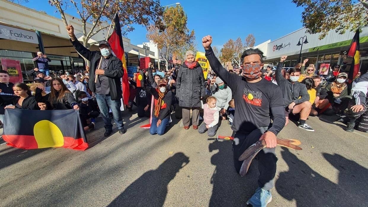 Former NRL player and Wiradjuri man Joe Williams takes a knee with protesters at Wagga Wagga. Former NRL player and Wiradjuri man Joe Williams kneels with protesters at Wagga Wagga Black Lives Matter rally.