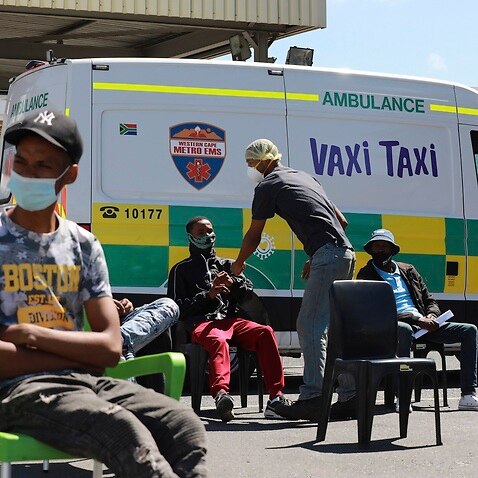 People wait to be vaccinated by the Western Cape Metro EMS at a mobile Vaxi Taxi, a mobile COVID-19 vaccination site in South Africa.