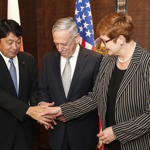 Japan's Itsunori Onodera, Jim Mattis and Marise Payne shake hands