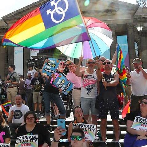 People gather in front of the State library of Victoria in Melbourne for the outcome of the Same Sex Marriage vote.