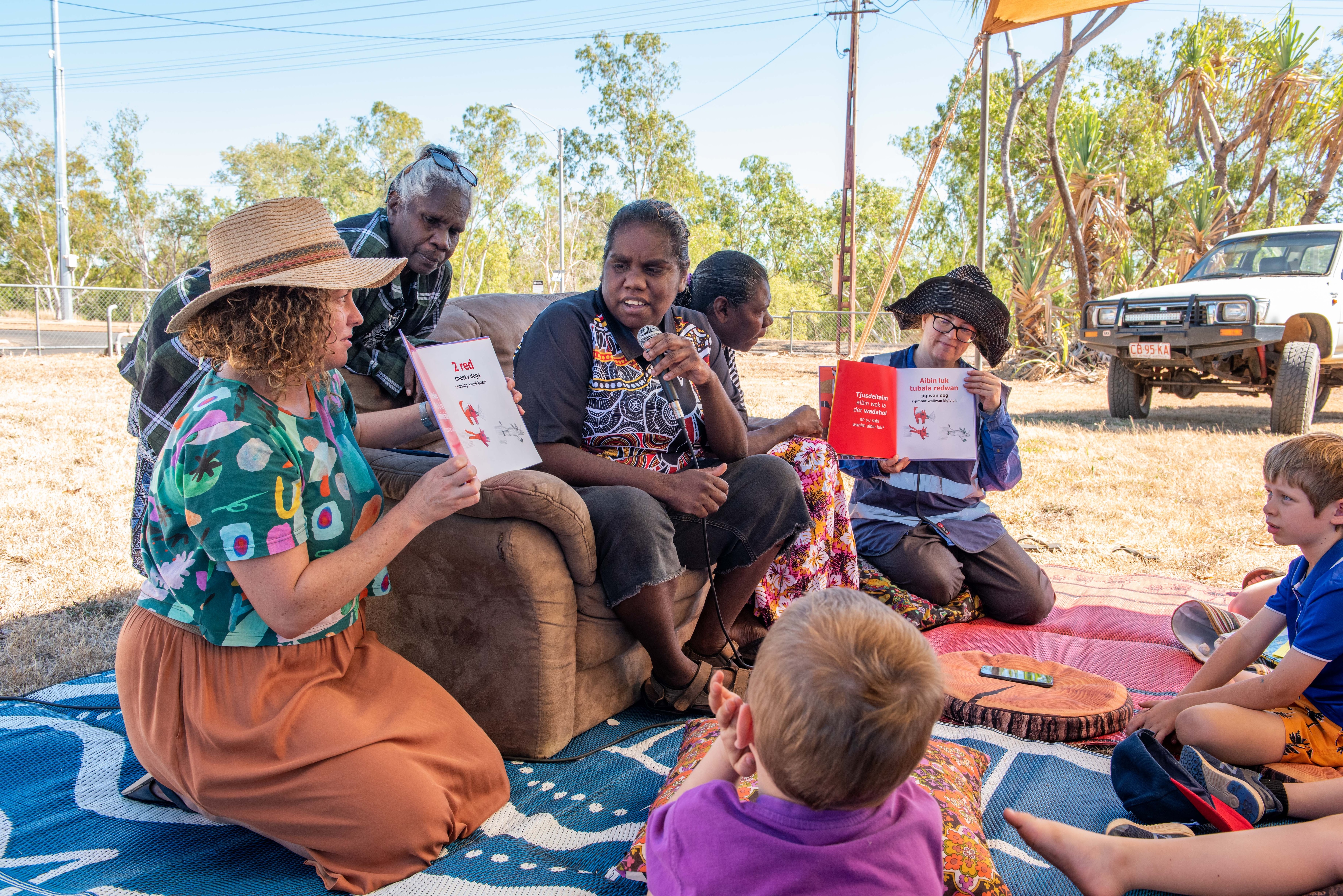 Shania Miller reads Bigismob Jigiwan Dog to a group of school children in Katherine, Northern Territory. 