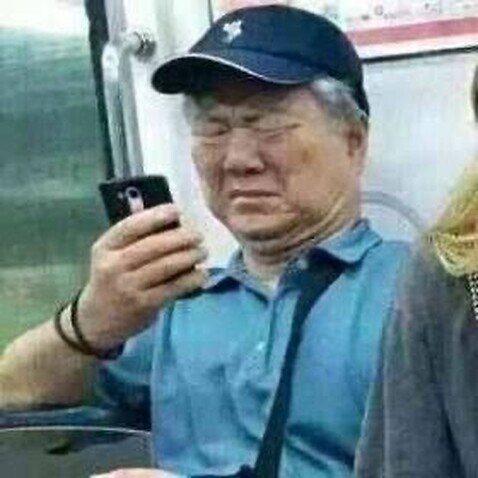 Elderly people looking at their mobile phones