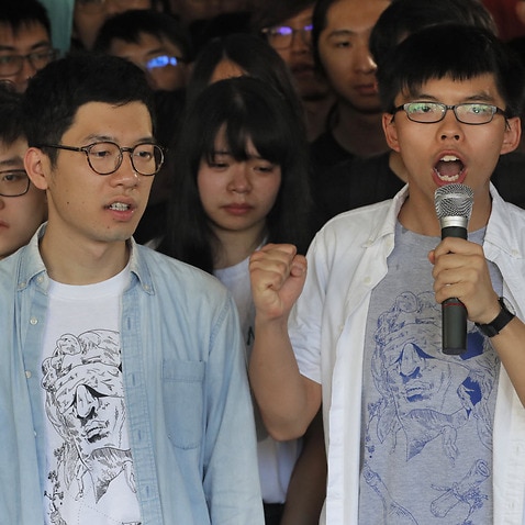 ong Kong activist Joshua Wong, right, and Nathan Law, left, speak outside the high court before a ruling on a prosecution request for stiffer sentences following a lower court decision that let them avoid prison in Hong Kong, 