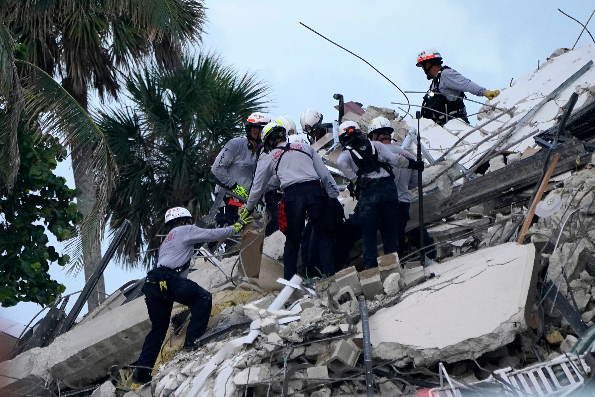 Rescue workers look through the rubble.