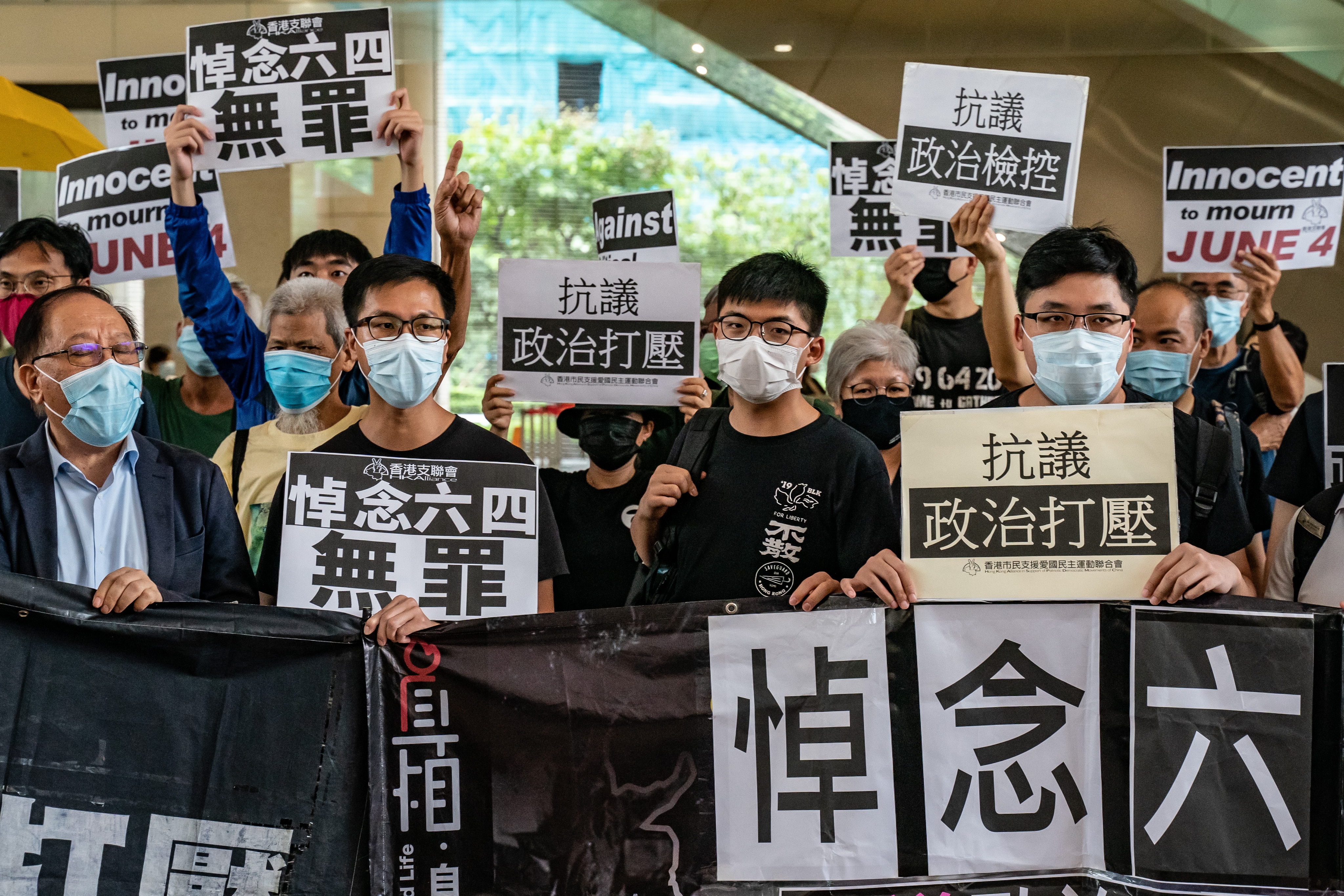 Hong Kong disqualified four opposition members of its legislature on Wednesday for endangering security.