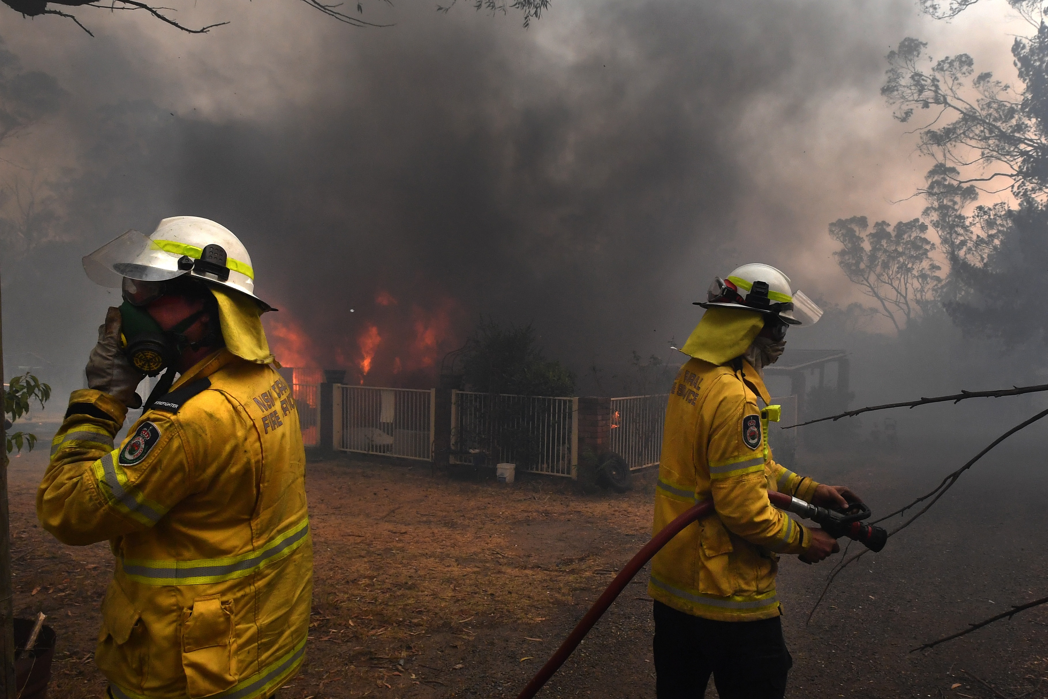 ural Fire Service crews douse a home lost to bushfire in Buxton as the Green Wattle Creek Fire threatens a number of communities south west of Sydney.