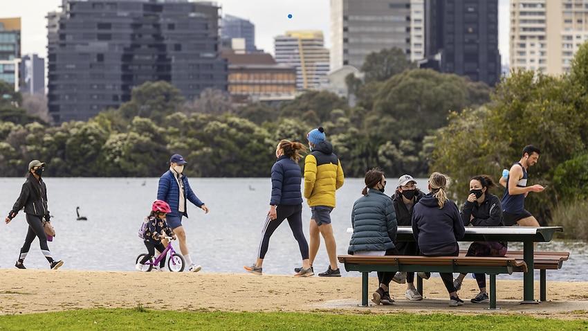 People are seen exercising and socialising at Albert Park Lake in Melbourne, 19 September 2021.