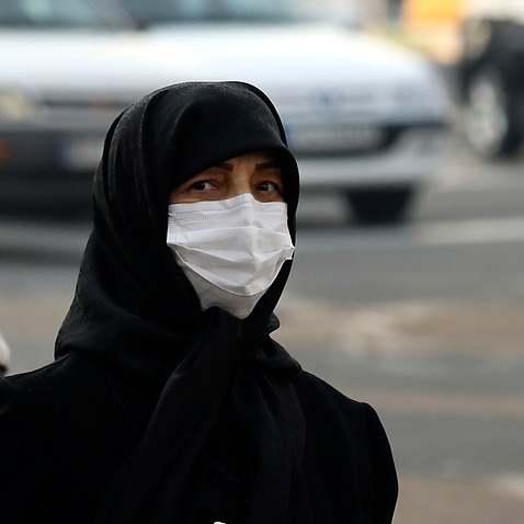 Pedestrians wearing face masks cross a square in western Tehran, Iran, Saturday, 29 February, 2020. 