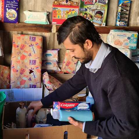 Mansoor Hashimi packing donations in his garage.