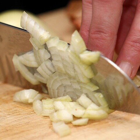 A general view of an onion being cut. Photo credit should read: Tim Goode/PA Wire..