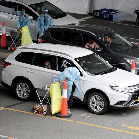 Cars queue as people wait to recieve a Covid test at a drive through testing facility at Sydney International Aiport, in Sydney, Wednesday, December 22, 2021. (AAP Image/Dan Himbrechts) NO ARCHIVING