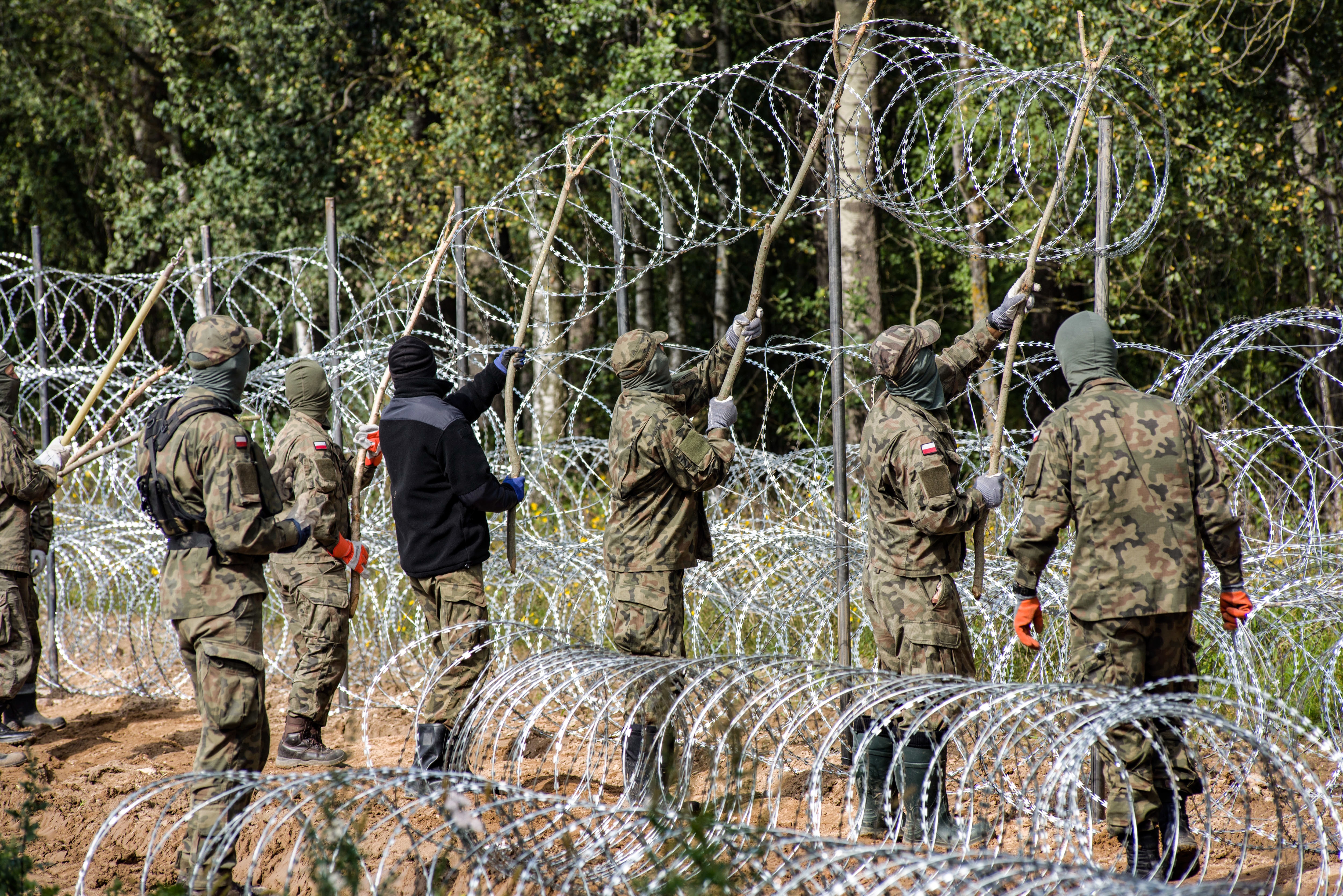 Poland has started building a barbed wire fence to curb the flow of migrants from countries such as Iraq and Afghanistan.
