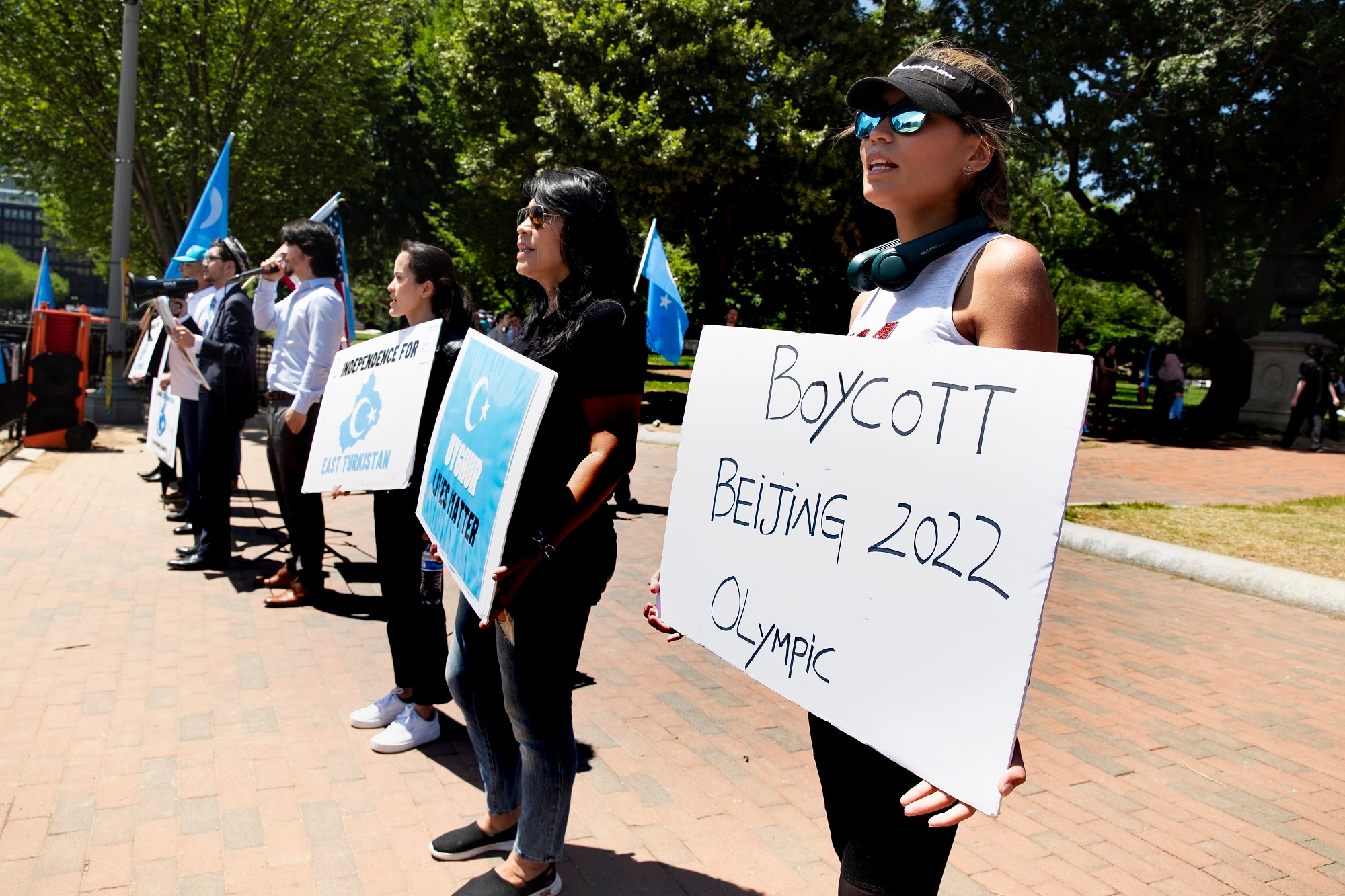 US activists outside the White House call for a boycott of the 2022 Winter Olympics and further action against China on 4 June 2021. 