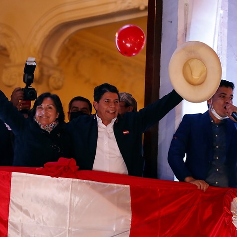 Pedro Castillo greets supporters from a balcony after being proclaimed president-elect of the country, in Lima, Peru, 19 July 2021.