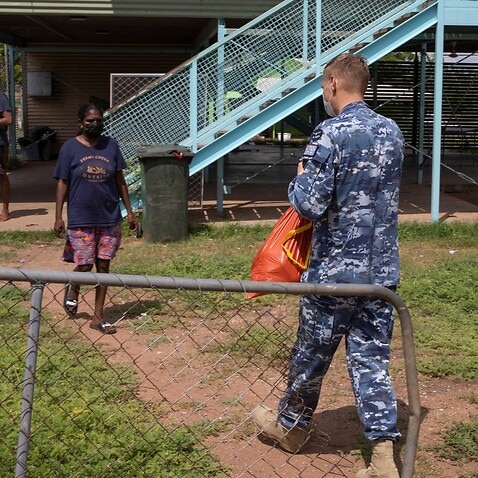 A supplied image obtained on Saturday, November 27, 2021, shows Flight Lieutenant Mark Tomlinson from Joint Task Force 629, deployed on Operation COVID Assist, delivering bags of food to the families at the Rockhole community in the Northern Territory.   