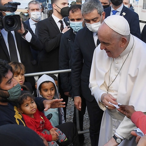 Pope Francis talks to people at the Reception and Identification Centre (RIC) in Mytilene on the island of Lesbos, Greece, 5 December 2021. 