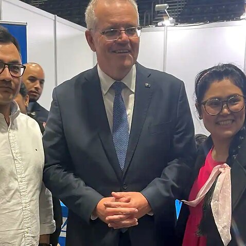 Omid Ahmadi (left) approached Prime Minister Scott Morrison asking for more help to get people from Afghanistan to Australia.