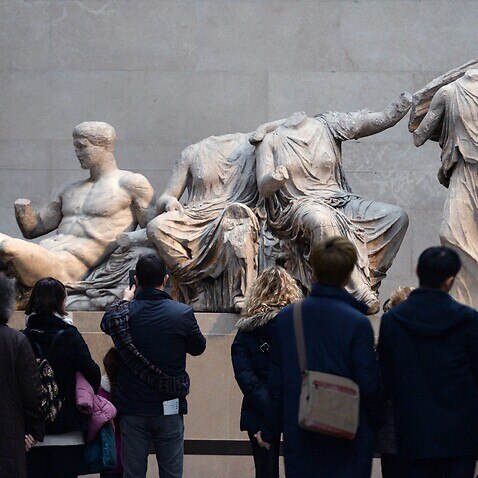 Visitors look at The Parthenon Marbles, also known as the Elgin Marbles in the British Museum in London