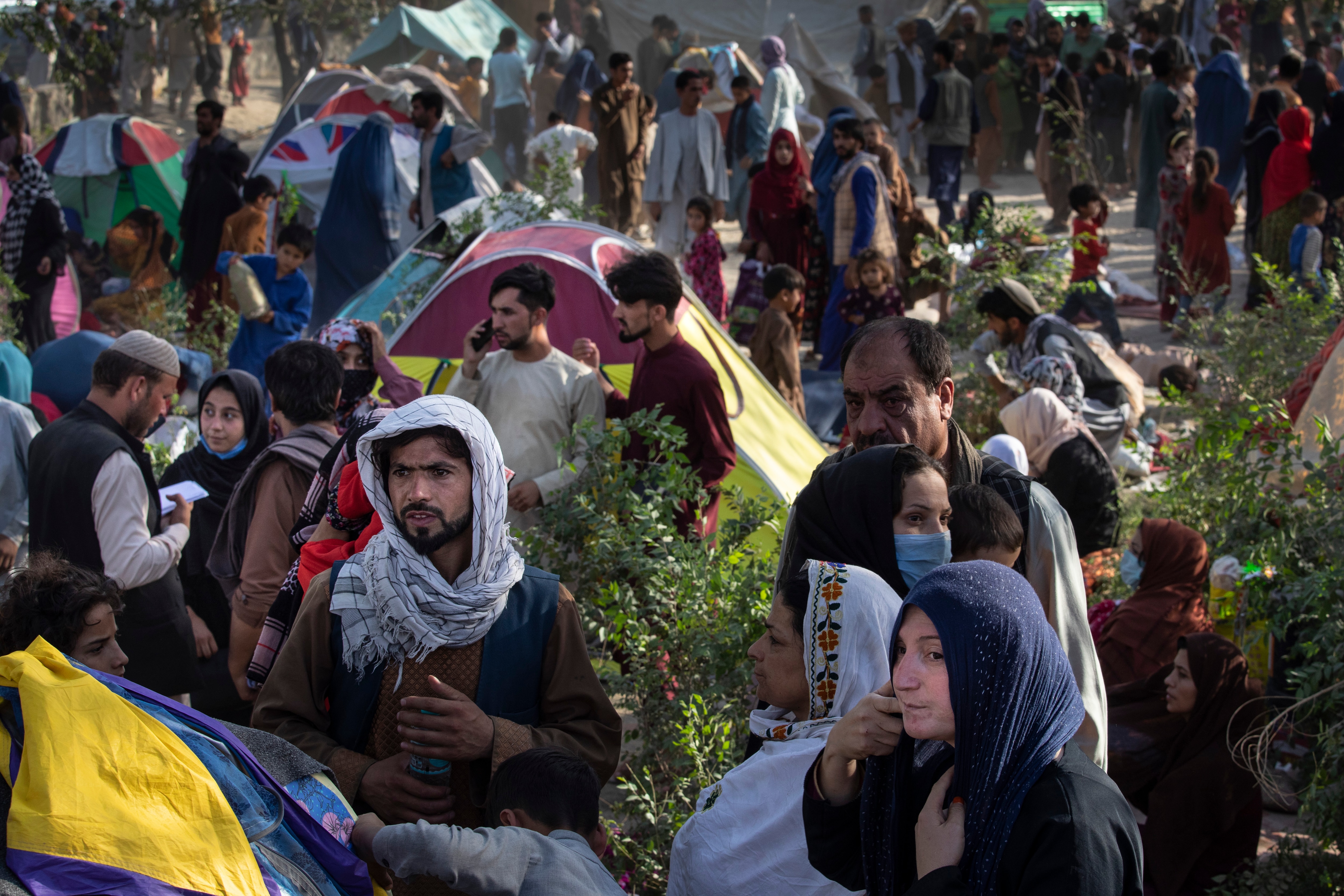 Displaced Afghans arrive at a makeshift camp in Kabul after desperately leaving their homes in the northern provinces behind on 10 August, 2021.