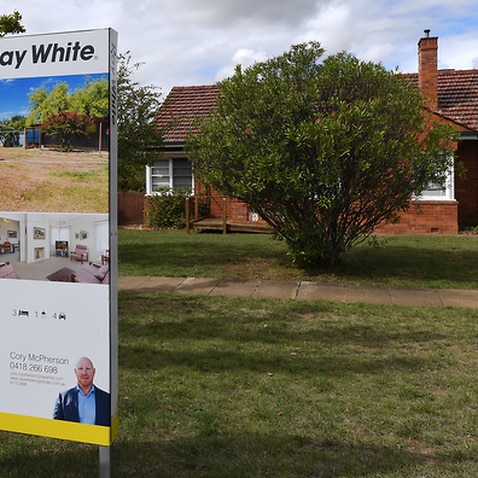 A real estate advertising board is seen in Canberra