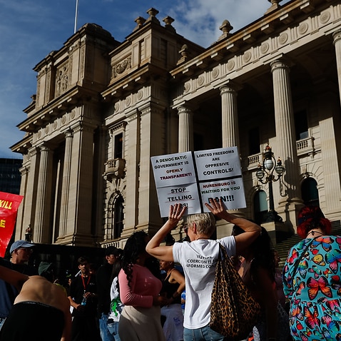 Protesters are seen during a demonstration outside the Victorian State Parliament, in Melbourne on 18 November, 2021. 