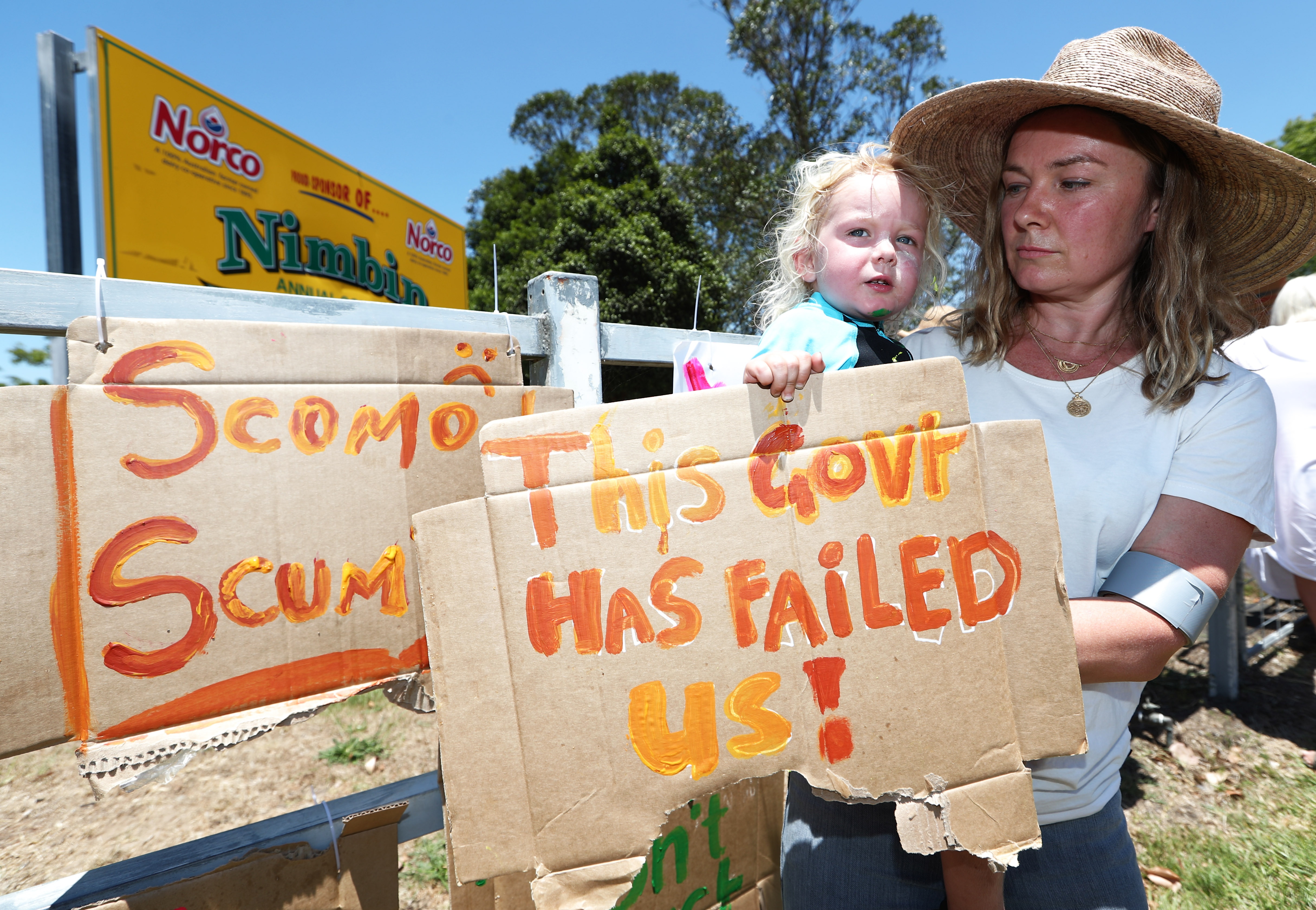 Tuntable Falls resident Amanda Collien and two-year-old daughter Etienne make their position known on the government's climate policies.