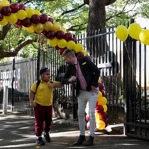 Staff welcome students back to school after COVID-19 restrictions were lifted, at Glebe Public School in Sydney.