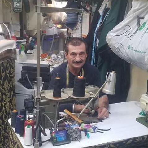Tailor Mohammad Badr, who runs his shop in the Sydney suburb of Bankstown (left), and a woman wearing his mask creation.