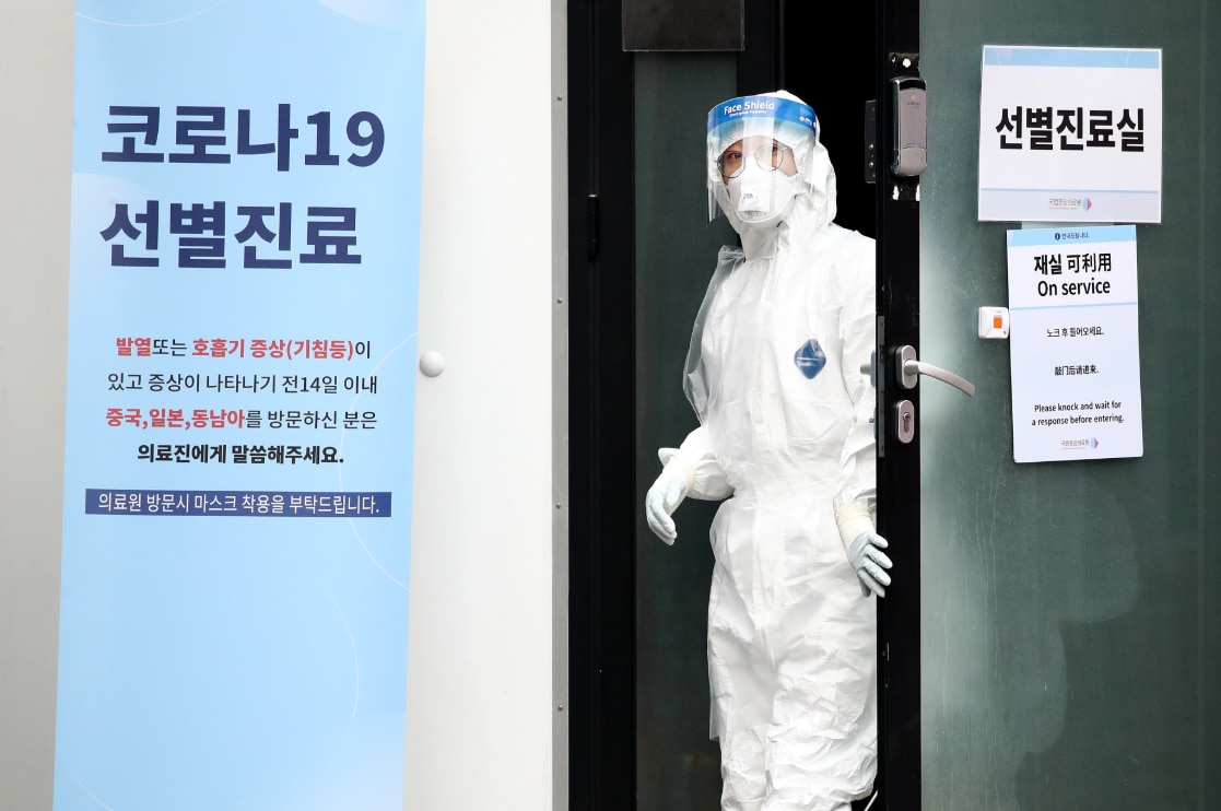 A medical professional is seen at a preliminary testing facility in Seoul, South Korea.
