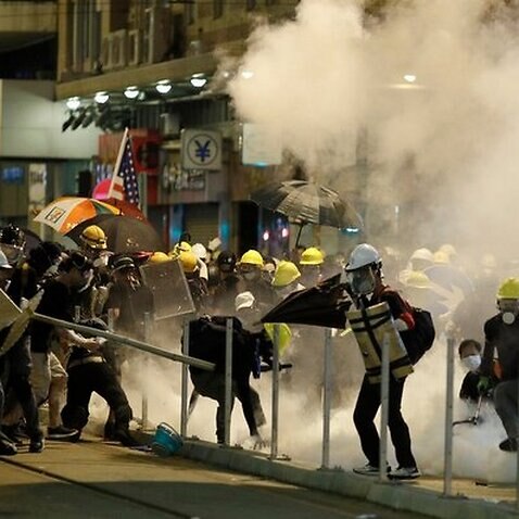 Hong Kong protesters react to teargas.