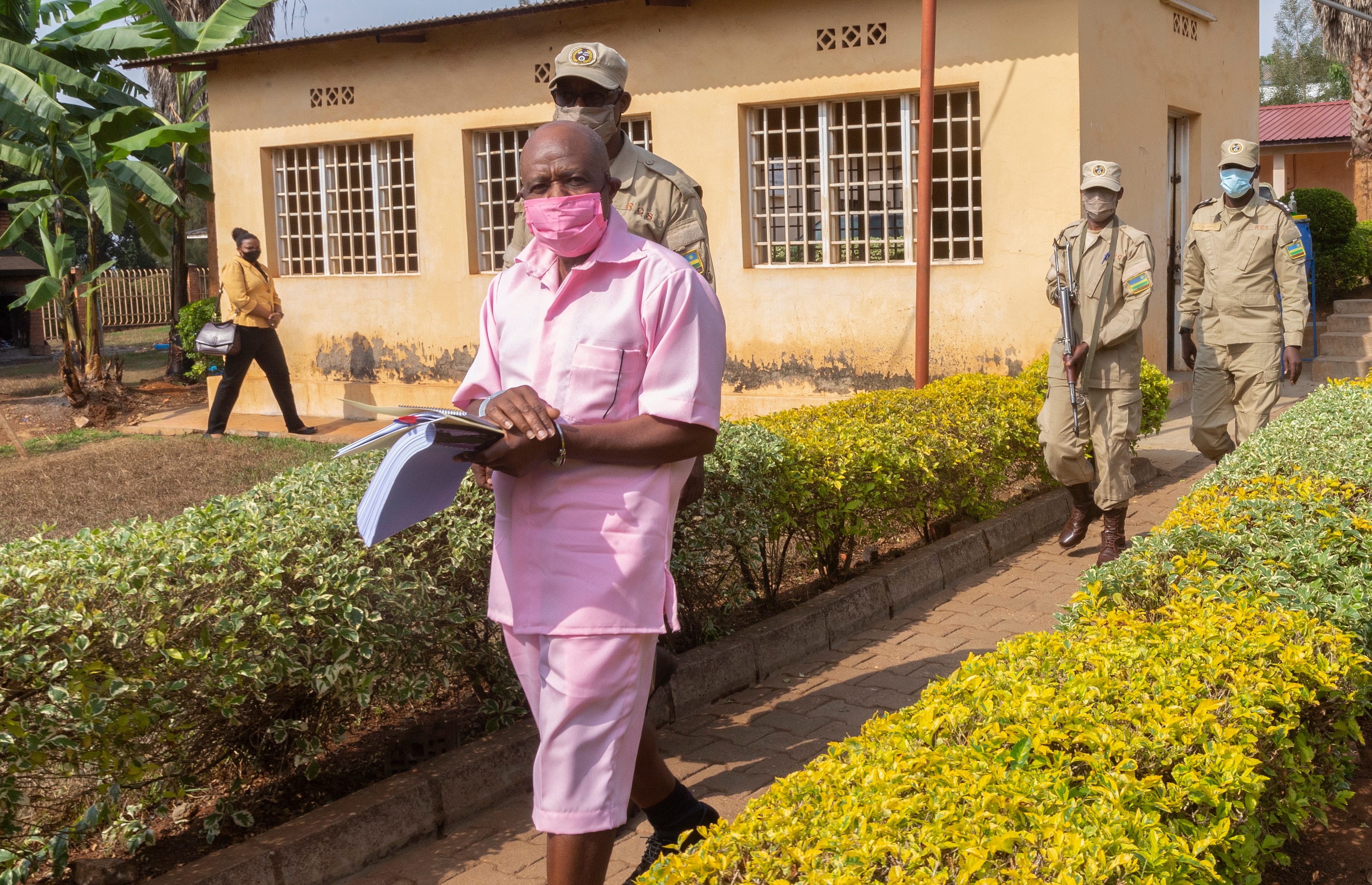 Paul Rusesabagina walks handcuffed with guards to attend a court hearing at the Kicukiro Primary court in Kigali, Rwanda, back in September 2020.