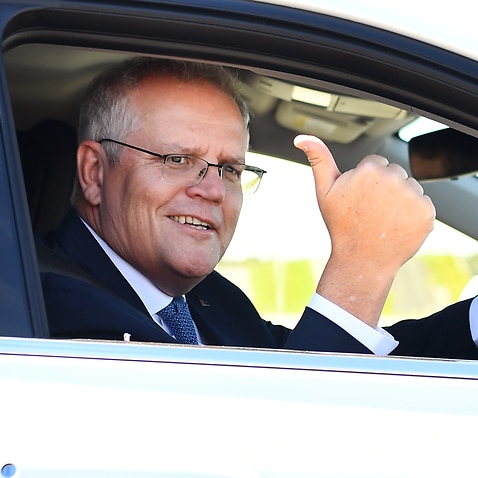 Prime Minister Scott Morrison drives a hydrogen-fuelled car around a Toyota test track in Melbourne.