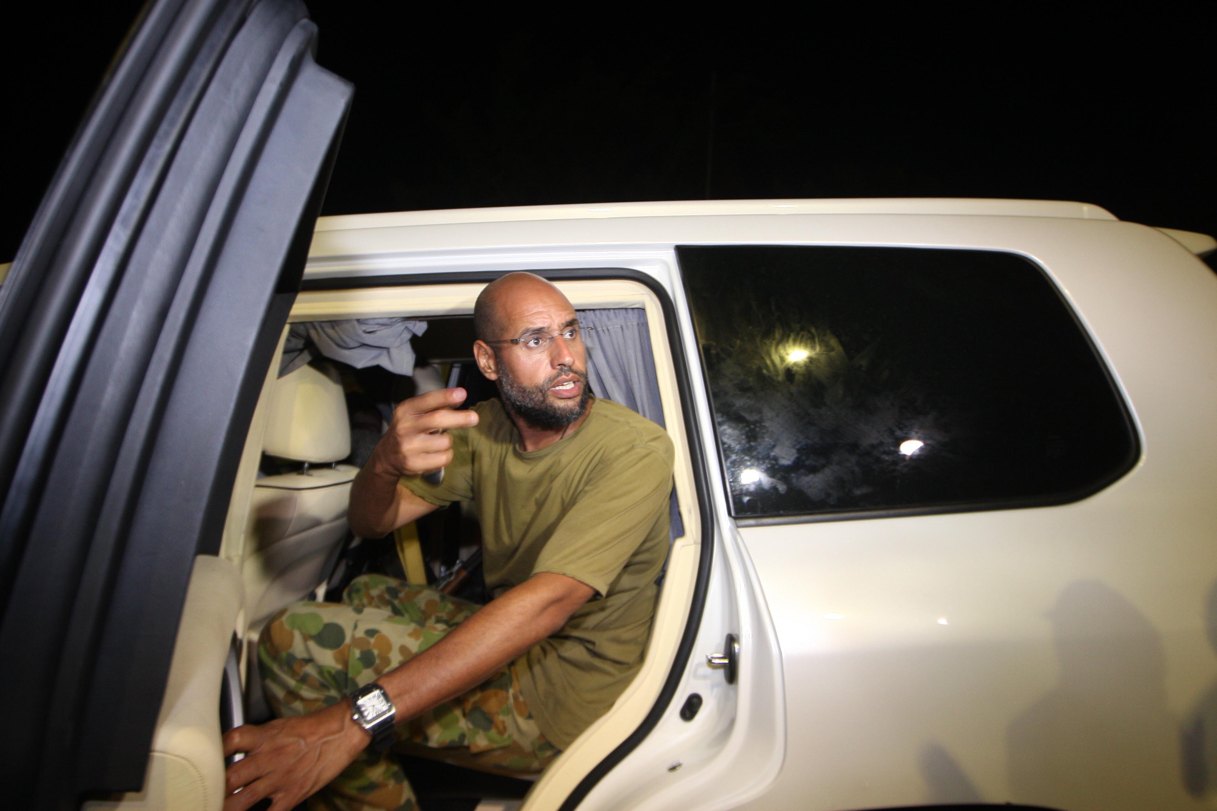 Saif al-Islam Kadhafi appears in front of supporters at his father's residential complex in the Libyan capital Tripoli in the early hours of August 23, 2011. 