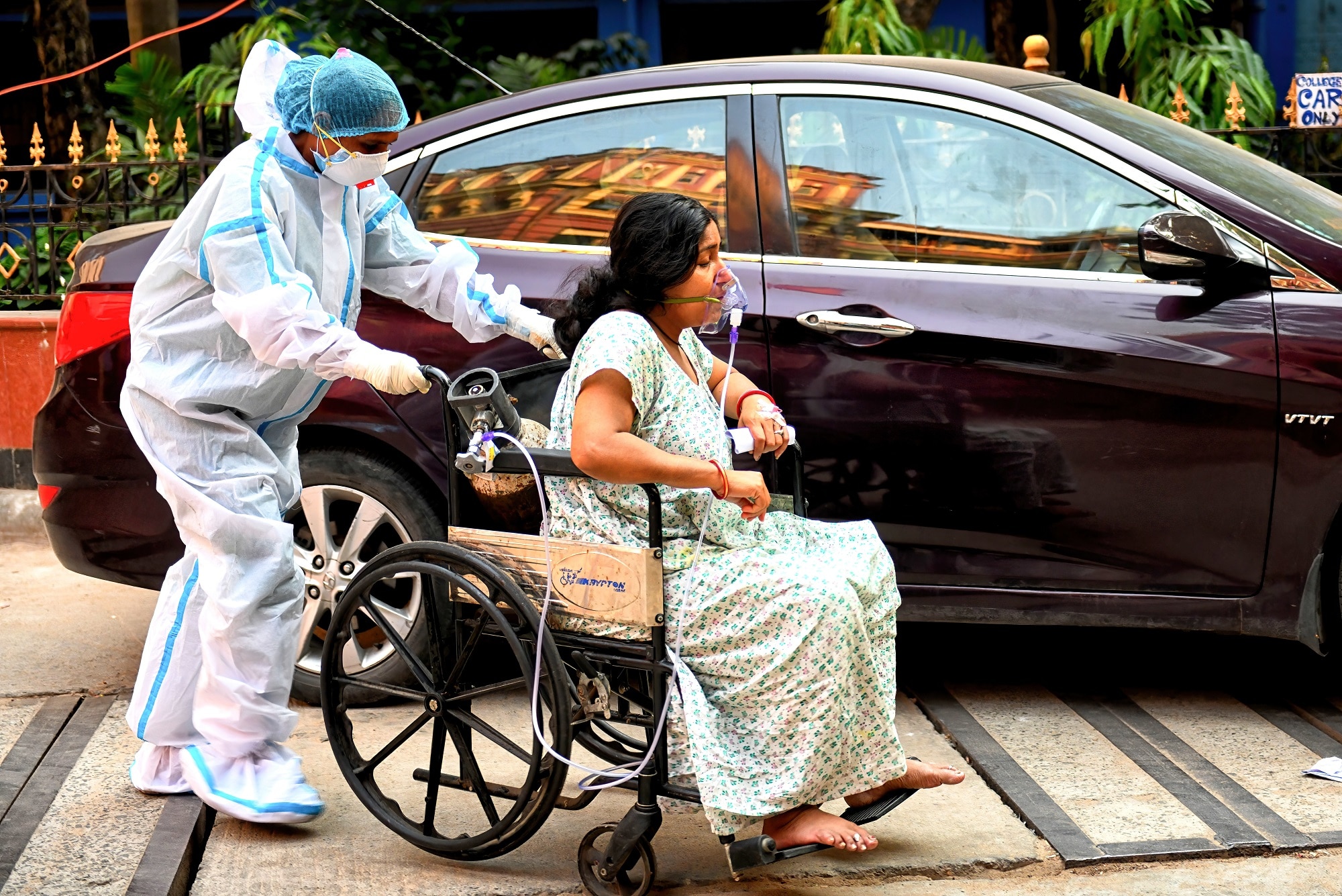 A COVID-19 patient on a wheelchair gets admitted at Kolkata Medical College Hospital in India. 
