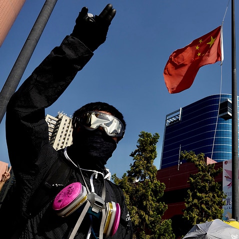 Protesters lower a Chinese national flag which they later set on fire in Hong Kong.