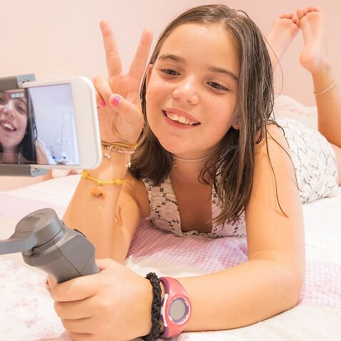 Young girl recording video to put on social media