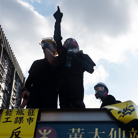 A protester points at the police during the demonstration in Hong Kong