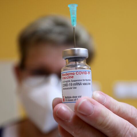 A doctor prepares a Moderna COVID-19 vaccine.