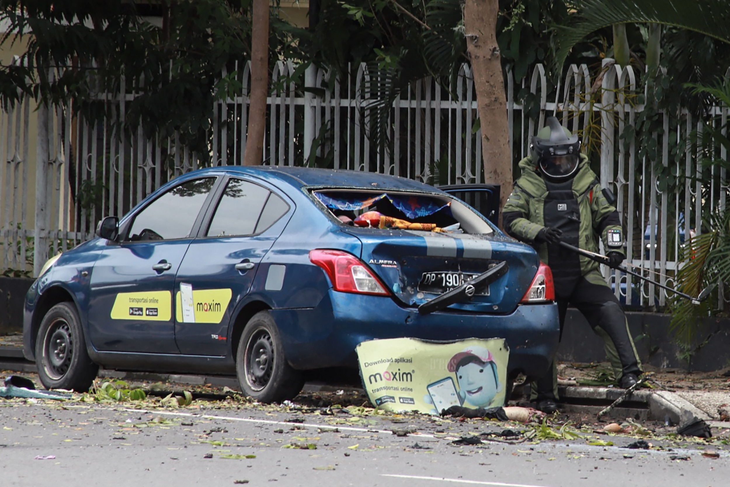 An Indonesian anti-bomb unit (C) collects evidences after a bomb exploded in Makassar.